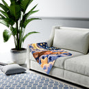 Blue Christian baby swaddle blanket with moon and puppy design draped on a sofa
